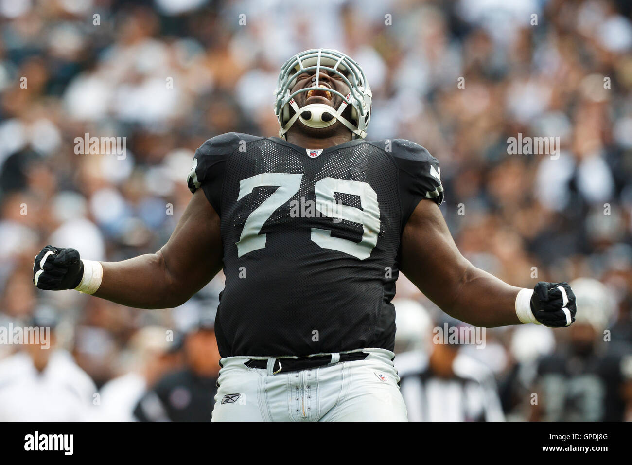 Sep 25, 2011; Oakland, CA, USA;  Oakland Raiders nose tackle John Henderson (79) celebrates after a play against the New York Jets during the fourth quarter at O.co Coliseum. Oakland defeated New York 34-24. Stock Photo