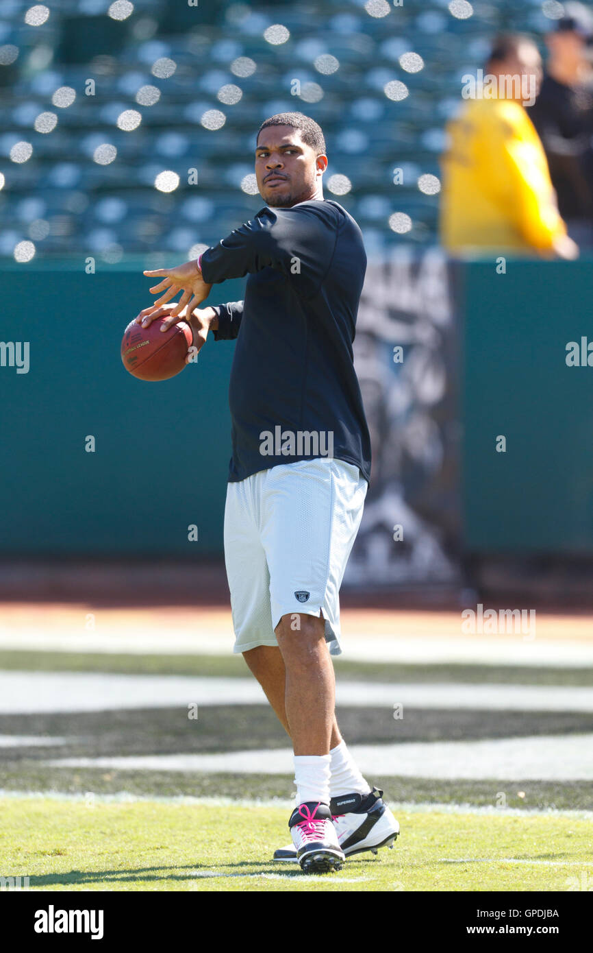 Oct 2, 2011; Oakland, CA, USA; Oakland Raiders quarterback Jason Campbell (8) warms up before the game against the New England Patriots at O.co Coliseum. Stock Photo