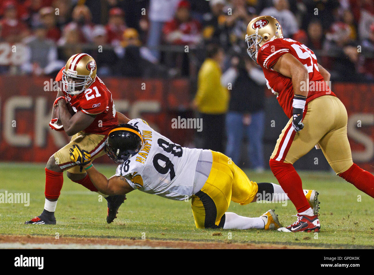 Dec 19, 2011; San Francisco, CA, USA; San Francisco 49ers running back Frank Gore (21) is tackled by Pittsburgh Steelers nose tackle Casey Hampton (98) during the second quarter at Candlestick Park. San Francisco defeated Pittsburgh 20-3. Stock Photo