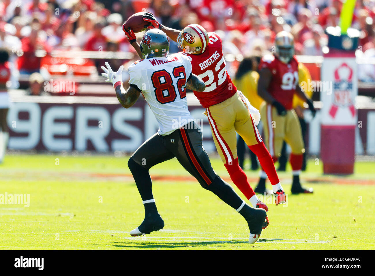 Oct 9, 2011; San Francisco, CA, USA; San Francisco 49ers cornerback Carlos Rogers (22) intercepts a pass intended for Tampa Bay Buccaneers tight end Kellen Winslow (82) during the second quarter at Candlestick Park. Rogers returned the interception for a Stock Photo