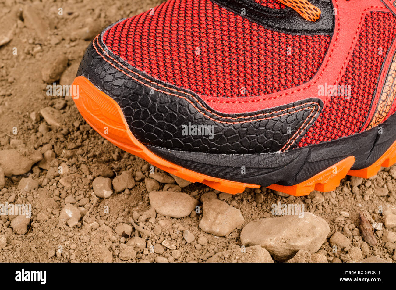 Trainers on rough unpaved ground during cross country running Stock