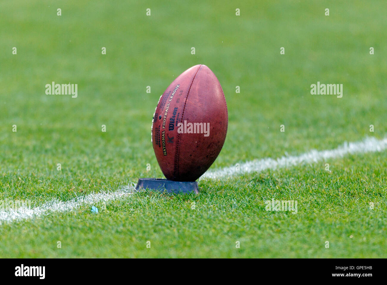 American football on kicking tee hires stock photography and images