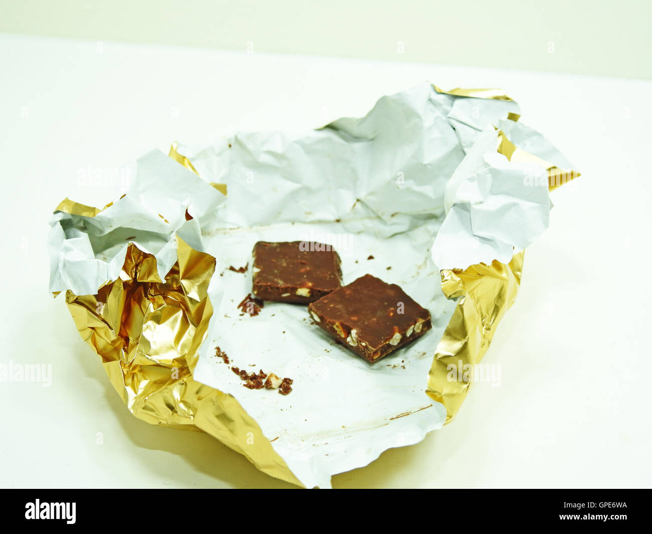 Chocolate bar in golden foil Stock Photo Alamy