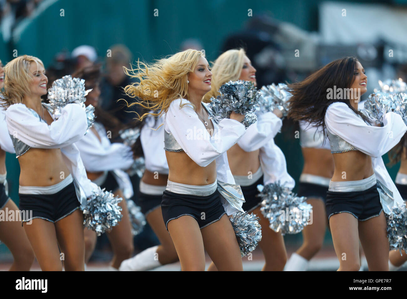 Jan 1, 2012; Oakland, CA, USA; Oakland Raiders cheerleaders perform in the end zone before the fourth quarter against the San Diego Chargers at O.co Coliseum. San Diego defeated Oakland 38-26. Stock Photo