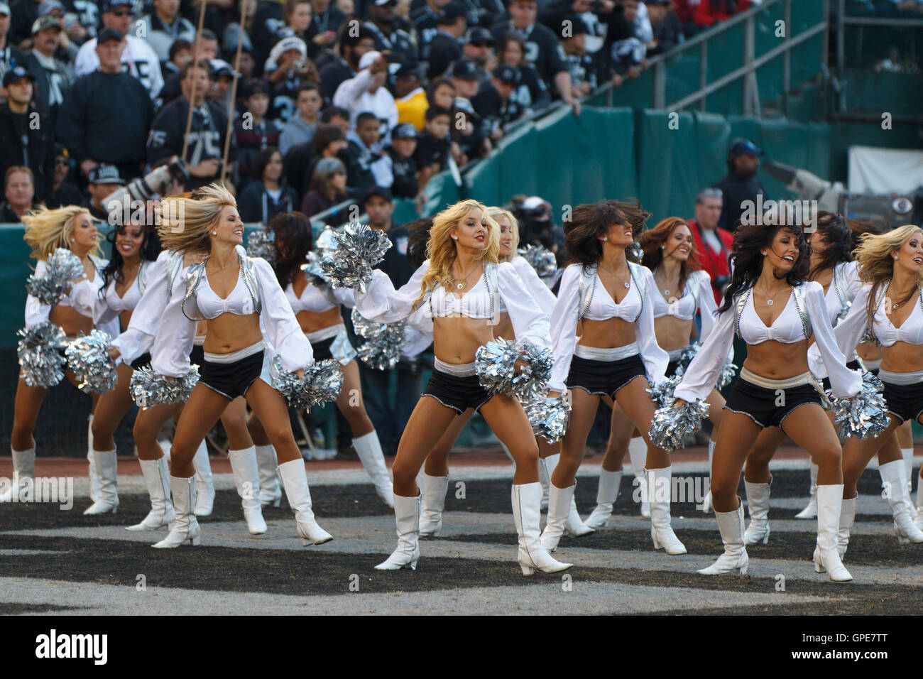 Jan 1, 2012; Oakland, CA, USA; Oakland Raiders cheerleaders perform in the end zone before the fourth quarter against the San Diego Chargers at O.co Coliseum. San Diego defeated Oakland 38-26. Stock Photo