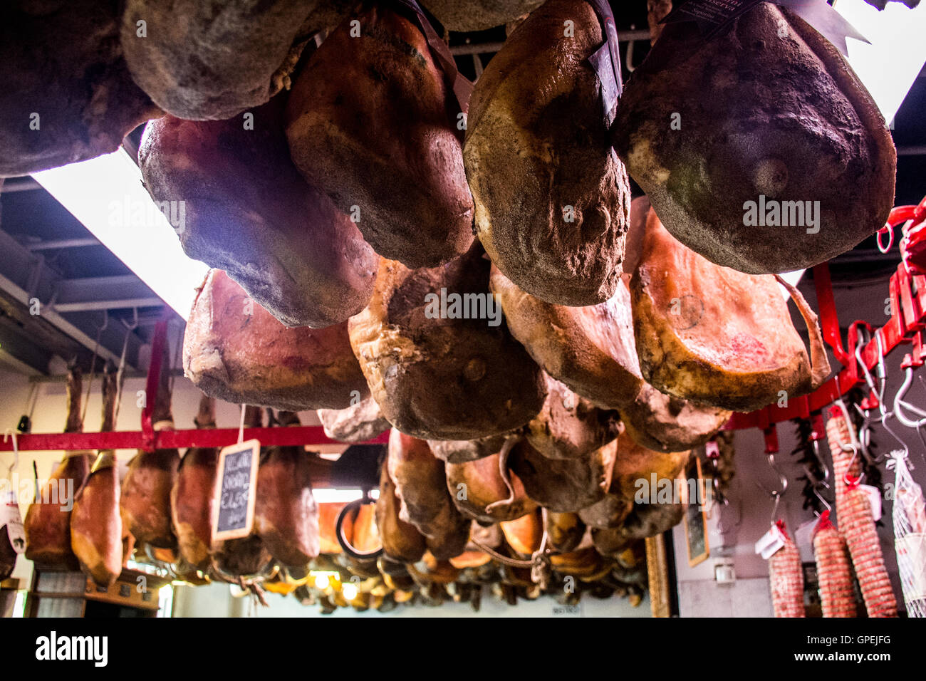 Original Italian prosciutto Meat hanging to dry in Italy Toscany Stock Photo