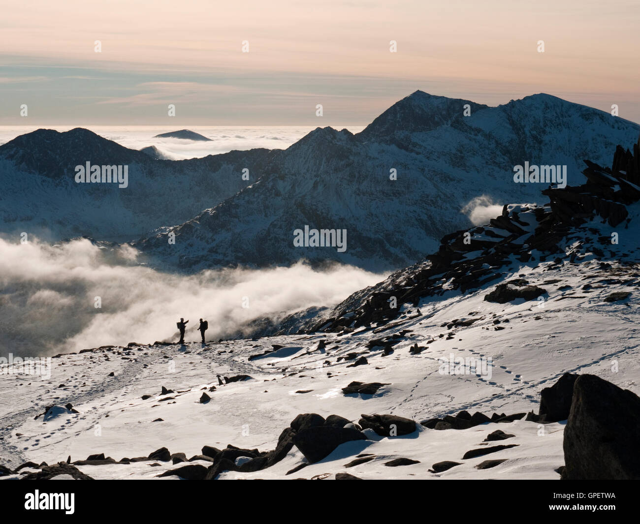 A wintery Snowdon viewed above a cloud inversion from Glyder Fach in the neighbouring Glyderau range of mountains, Snowdonia National Park Stock Photo