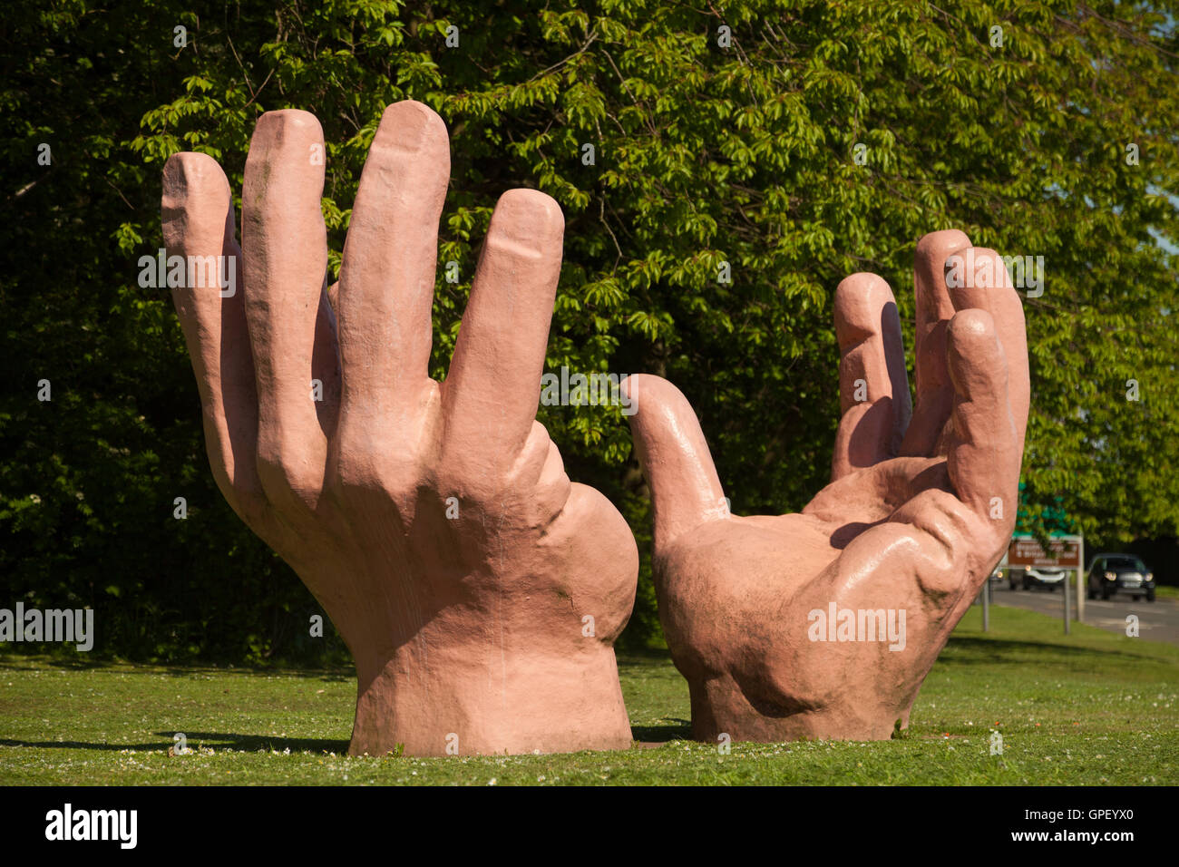 Large sculpture hands coming out of the ground in Glenrothes, Fife, Scotland. Stock Photo