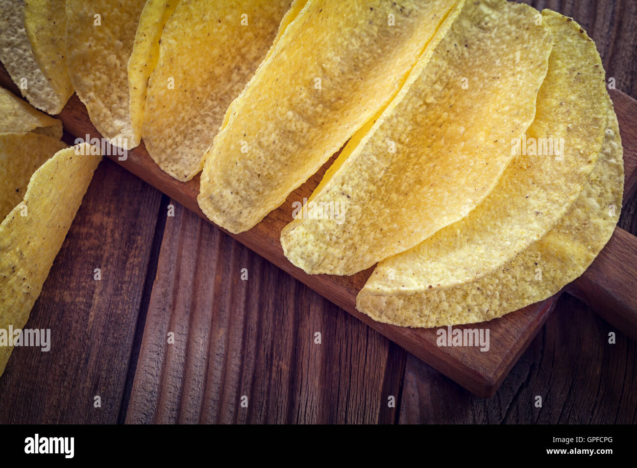 Tacos Mexican yellow corn tortilla , empty shell on wooden cutting