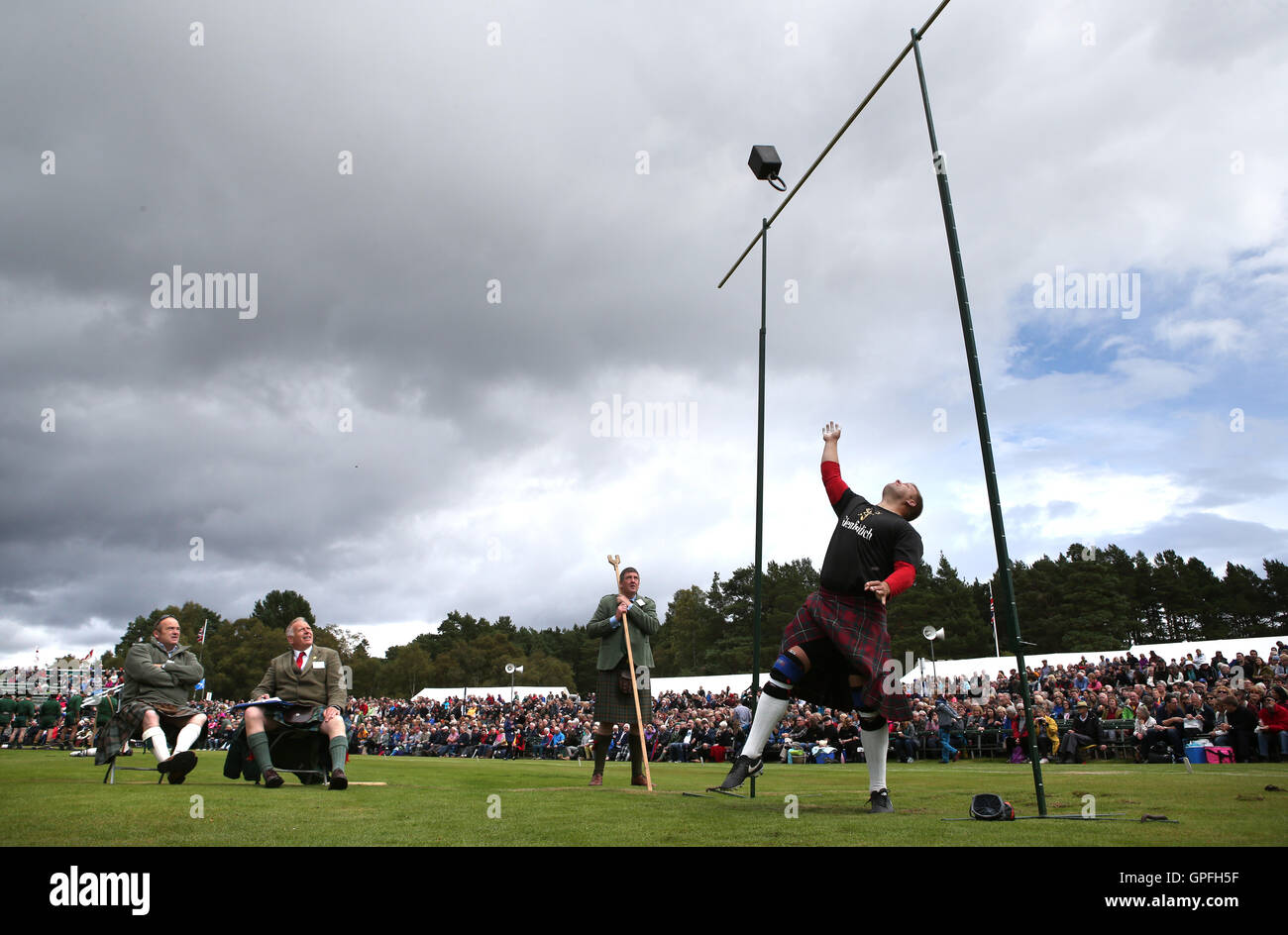 Competitor Scott Rider throws a weight over a high bar as he takes part