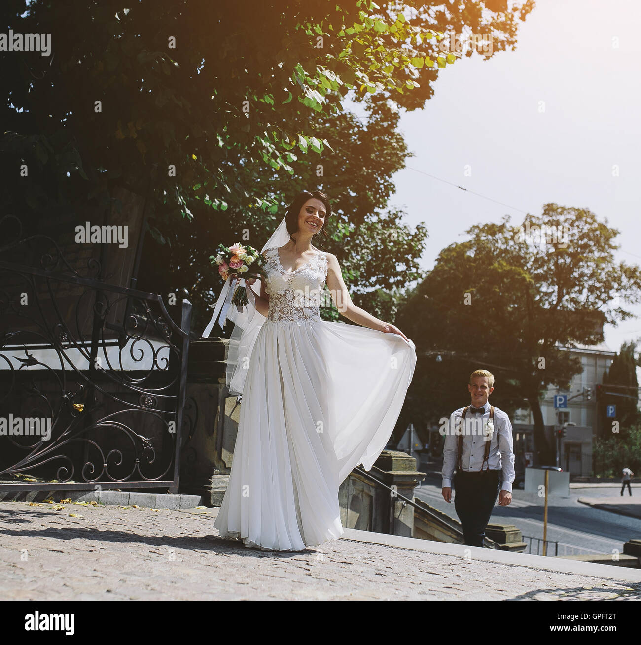 bride and groom posing on the streets Stock Photo - Alamy