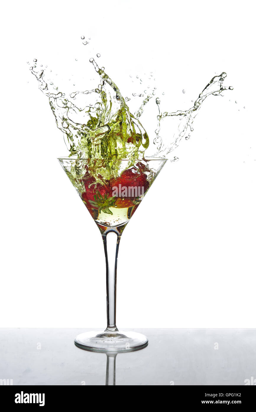 Splashing cocktail spilling out of martini glass Stock Photo Alamy