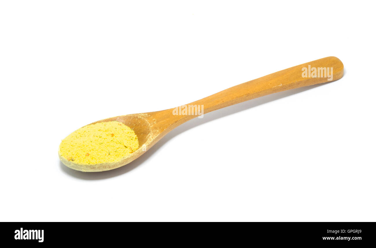 wooden spoon with vegeta spice isolated on white background. Stock Photo