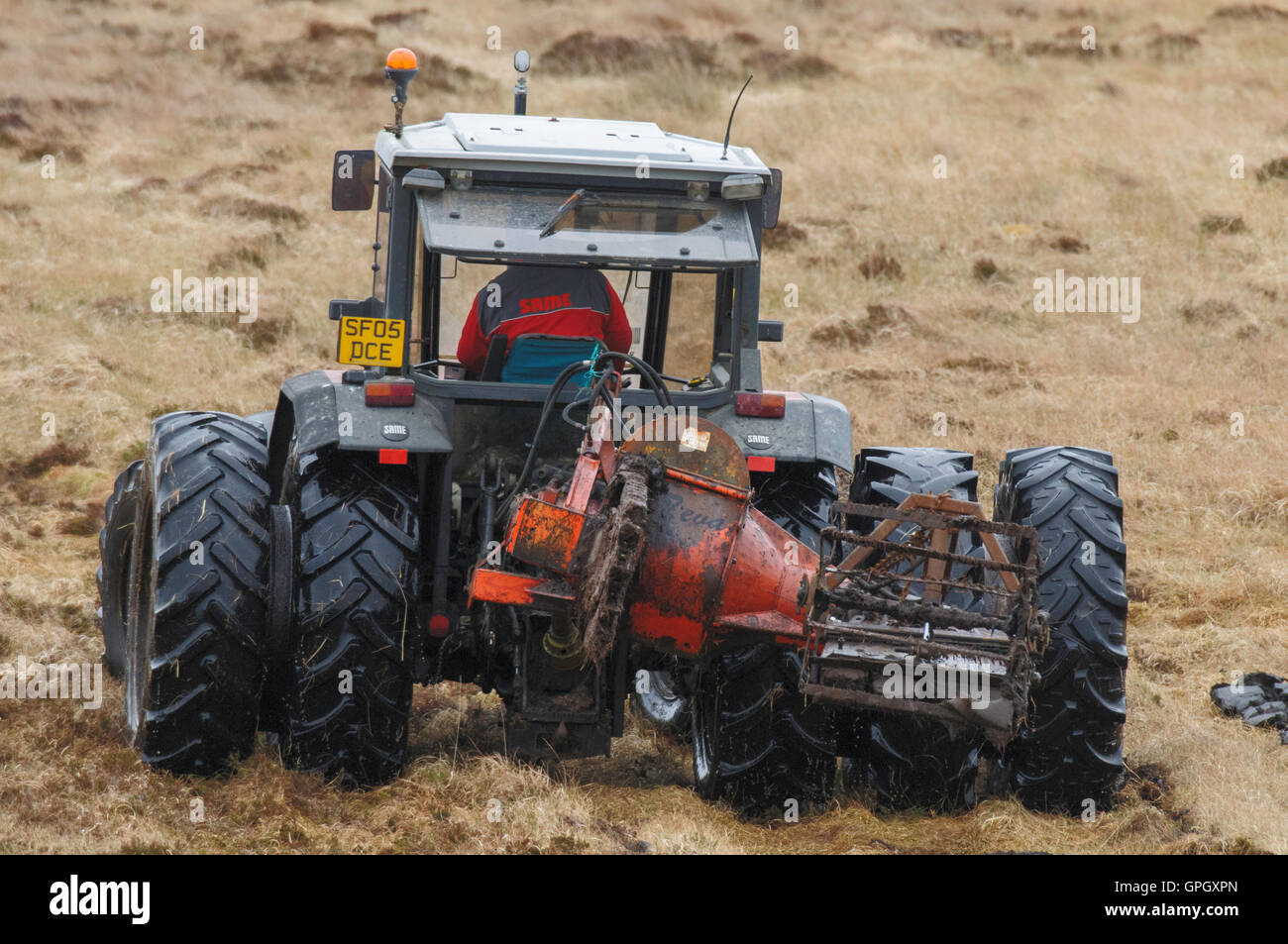 Peat cutting tractor fitted with dual wheels and working on the