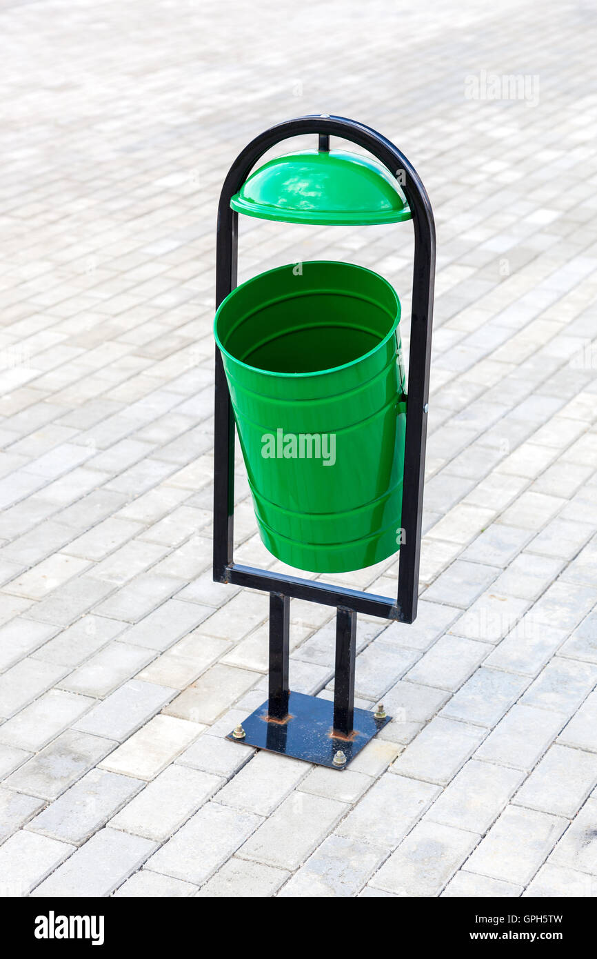 Metal green trash can on the street, summertime Stock Photo Alamy