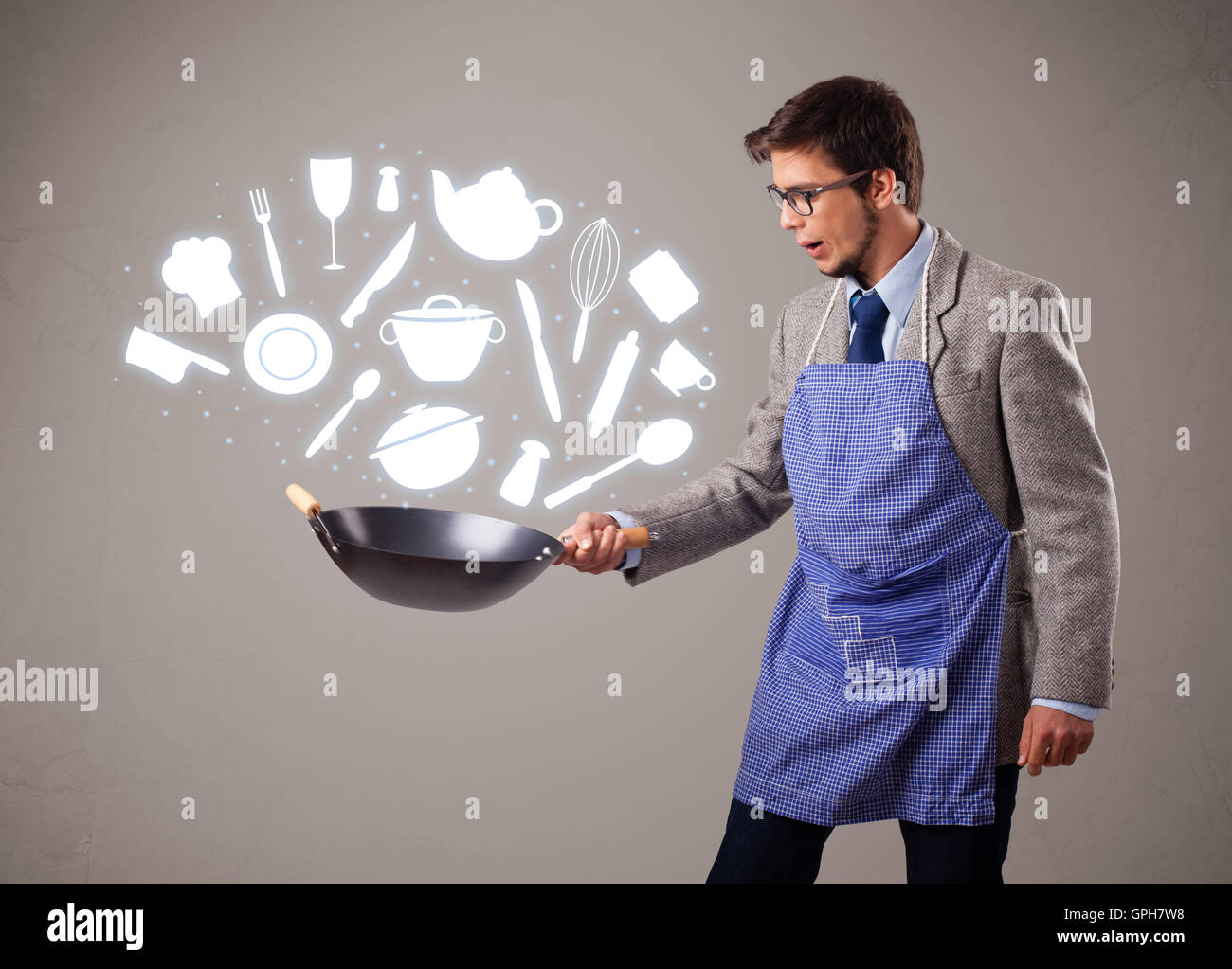 Handsome man with kitchen accessories icons Stock Photo - Alamy