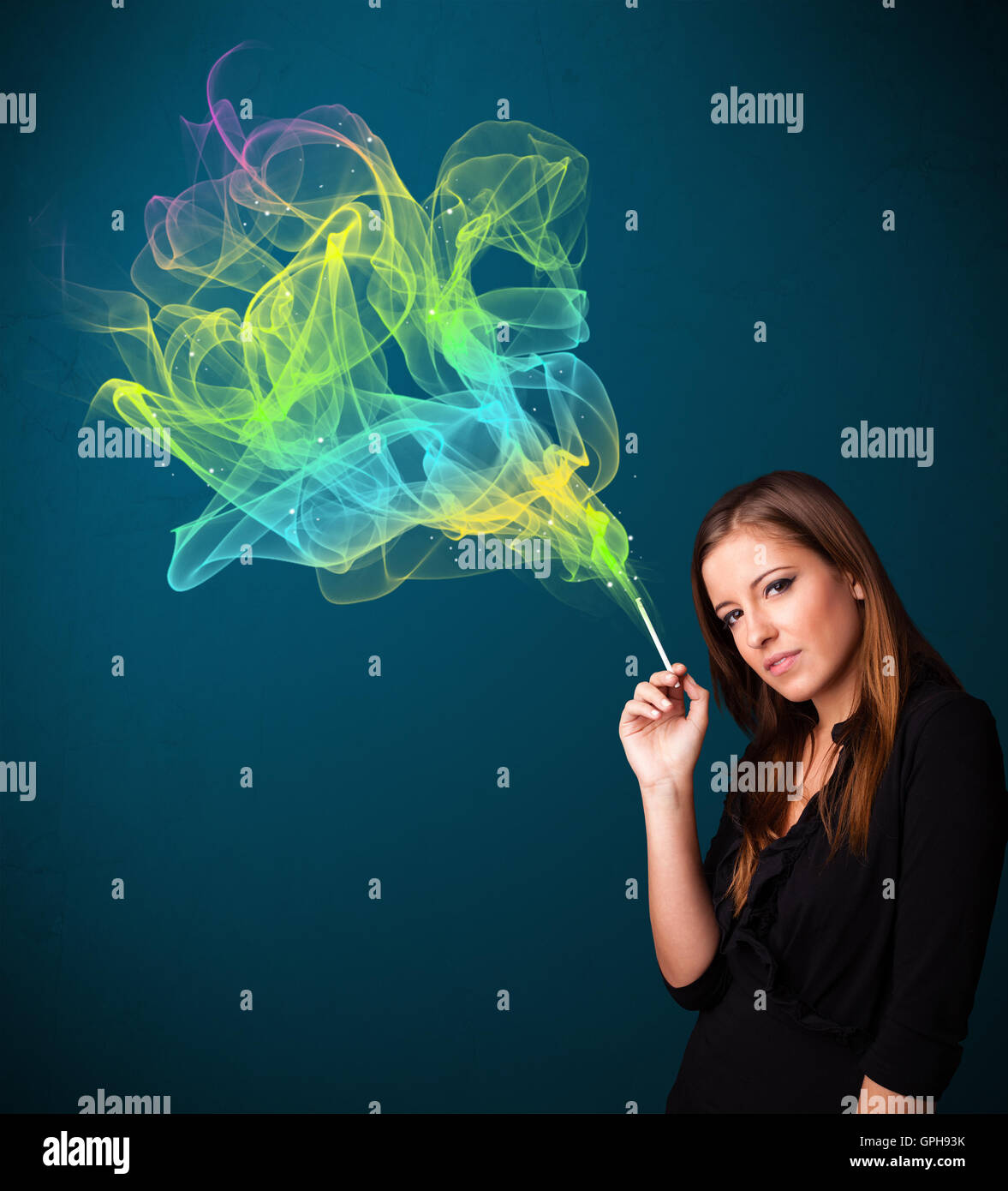 Pretty lady smoking cigarette with colorful smoke Stock Photo