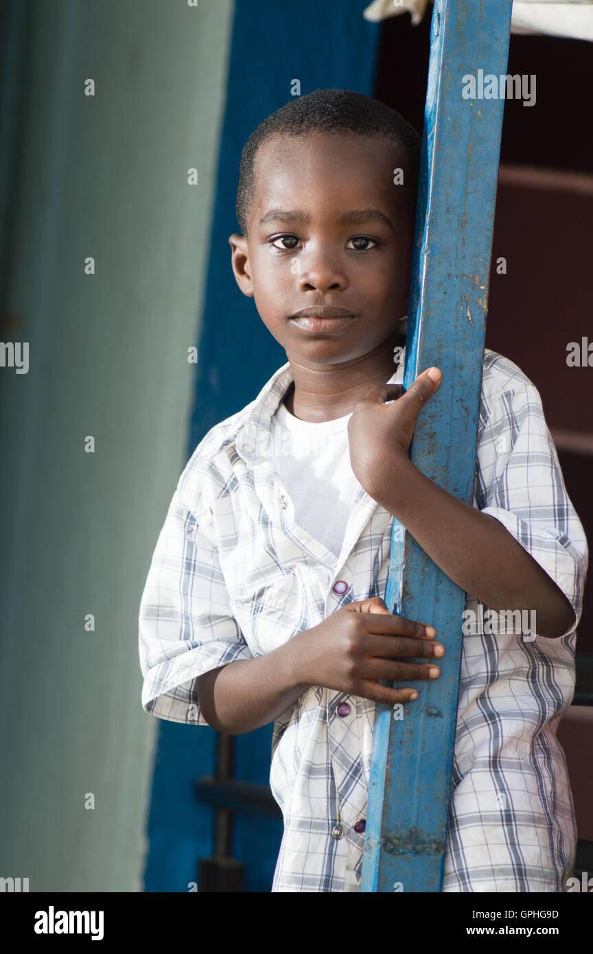 A child standing near an iron pillar and looking at the camera Stock ...