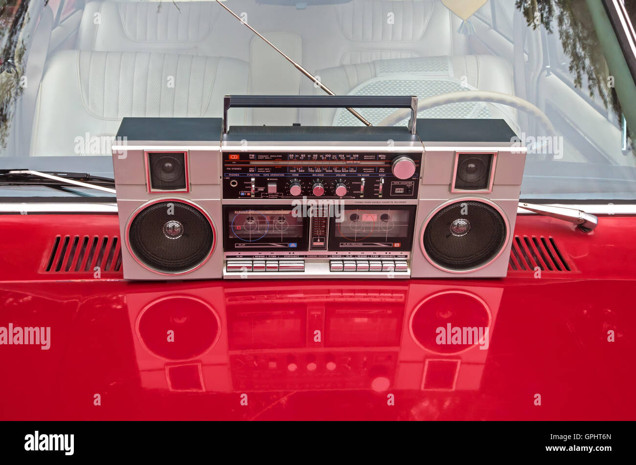 Device for sound playback and recording is on the hood of a retro car Stock Photo