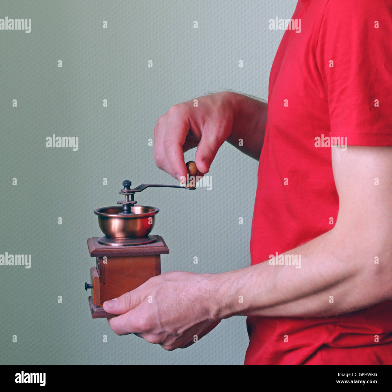 man with a wooden vintage coffee grinder Stock Photo Alamy