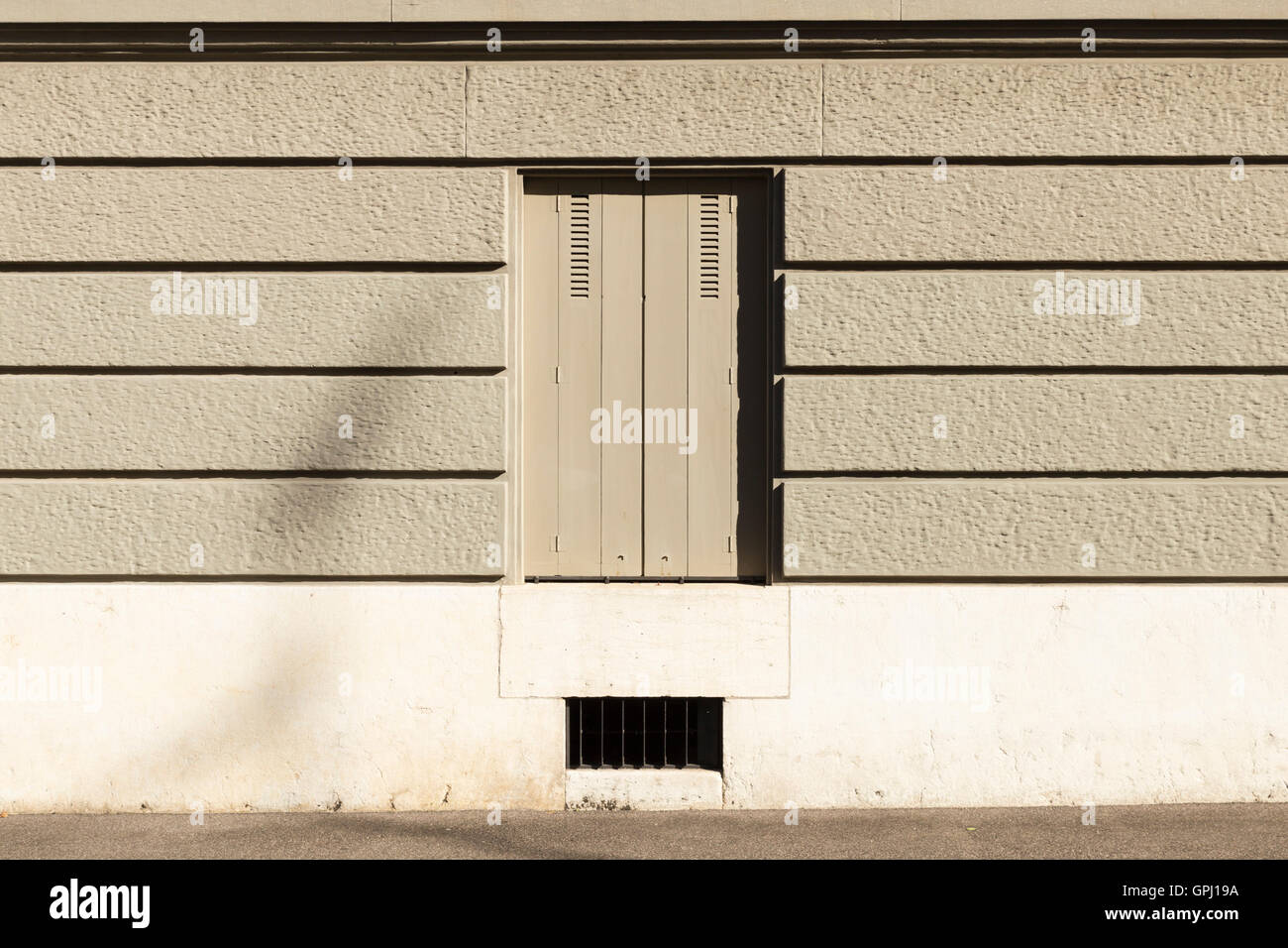 A Gray Painted Wall With Horizontal Stripes And A Window