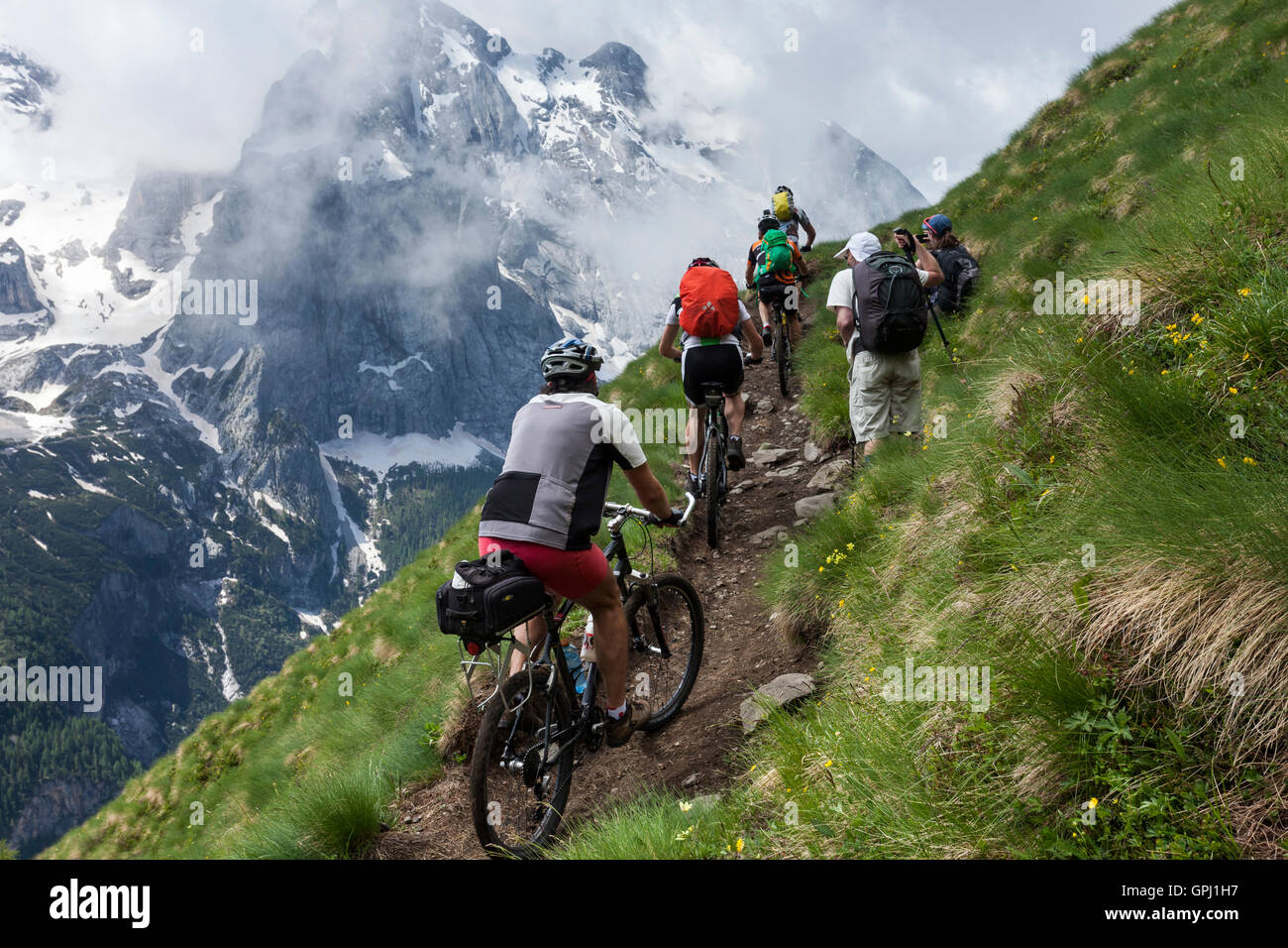 Mountain biking in front of Marmolada mountain in South Tyrol, Dolomites, Italy Stock Photo