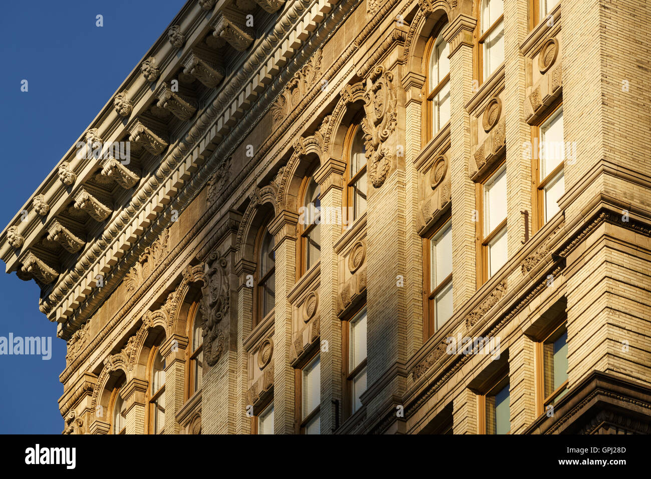 Soho brick building facades and cornices with terracotta architectural ornaments. Manhattan, New York City Stock Photo