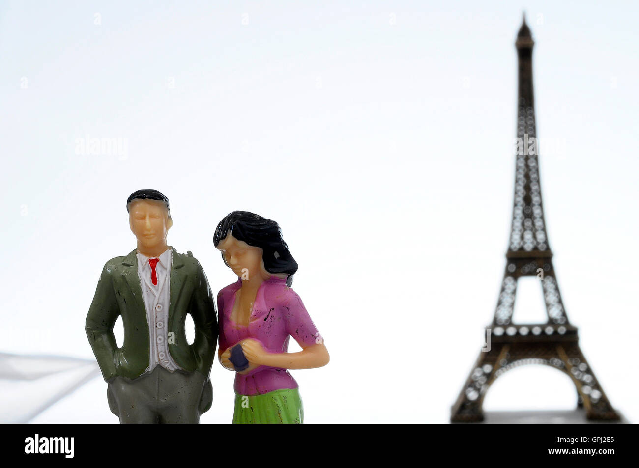 Scene of french people miniature figures in front of Paris Eiffel tower Stock Photo