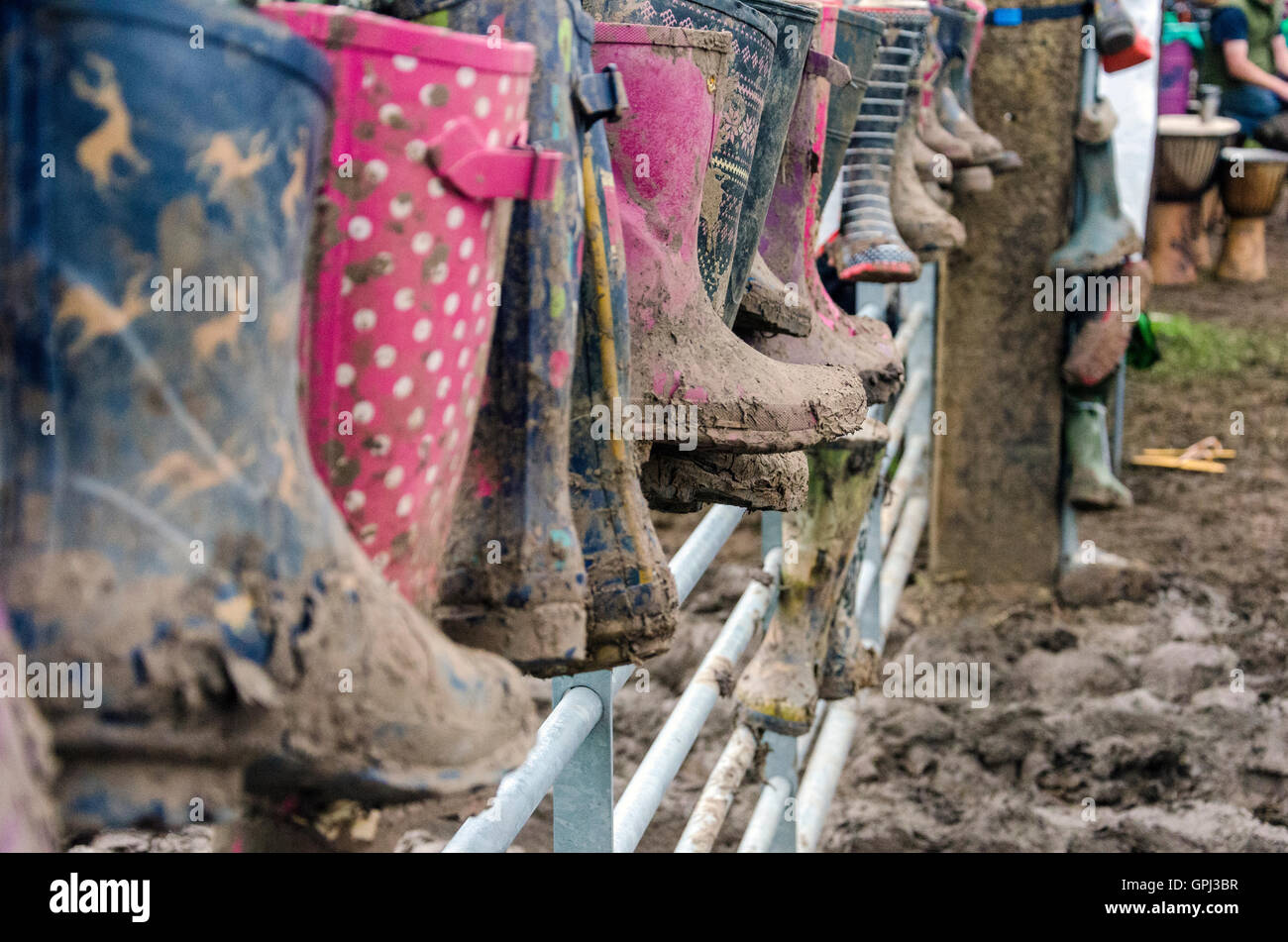 Wellies attached to a gate at Glastonbury Festival of contemporary performing arts 2016 Stock Photo