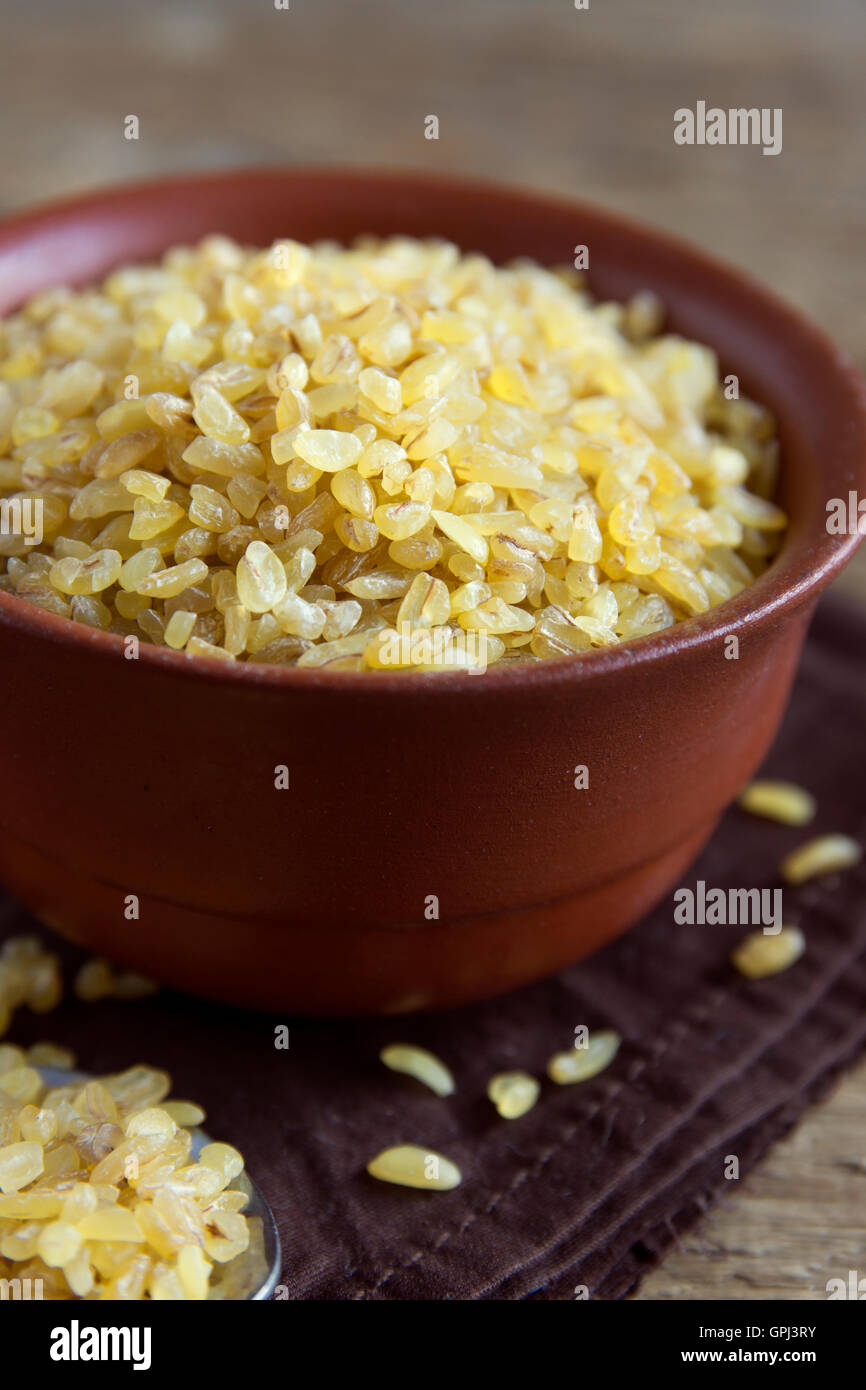 Organic bulgur raw wheat grain in ceramic bowl close up Stock Photo - Alamy