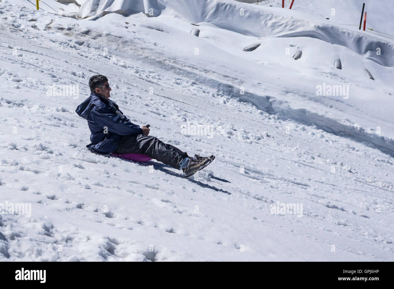 Male Indian tourist riding a sleigh at the glacier park on Titlis glacier  in summer. Engelberg, Obwalden, Switzerland Stock Photo - Alamy