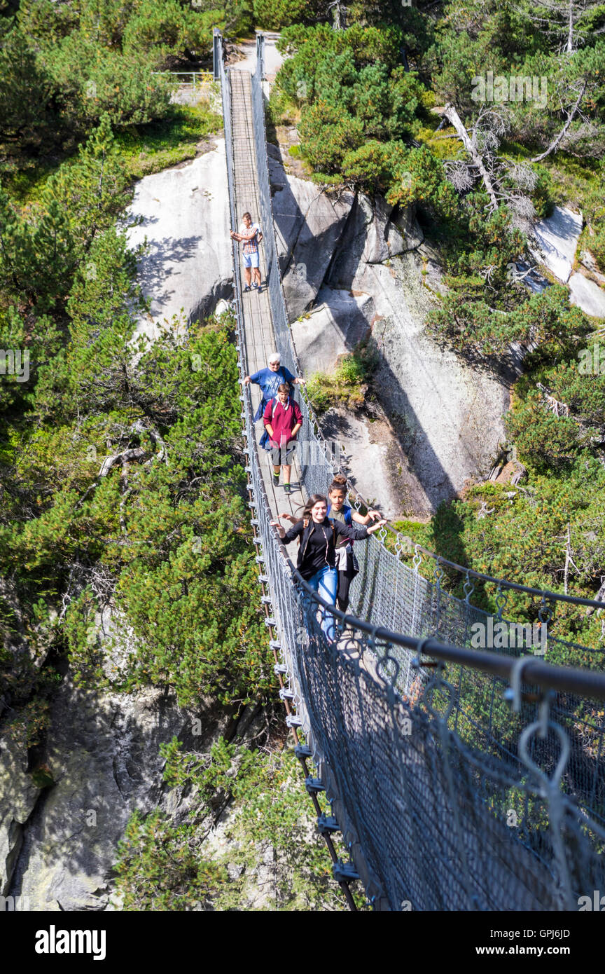 70m long and high pedestrian suspension bridge in the Alps. Handegg, Berner Oberland, Switzerland. Stock Photo