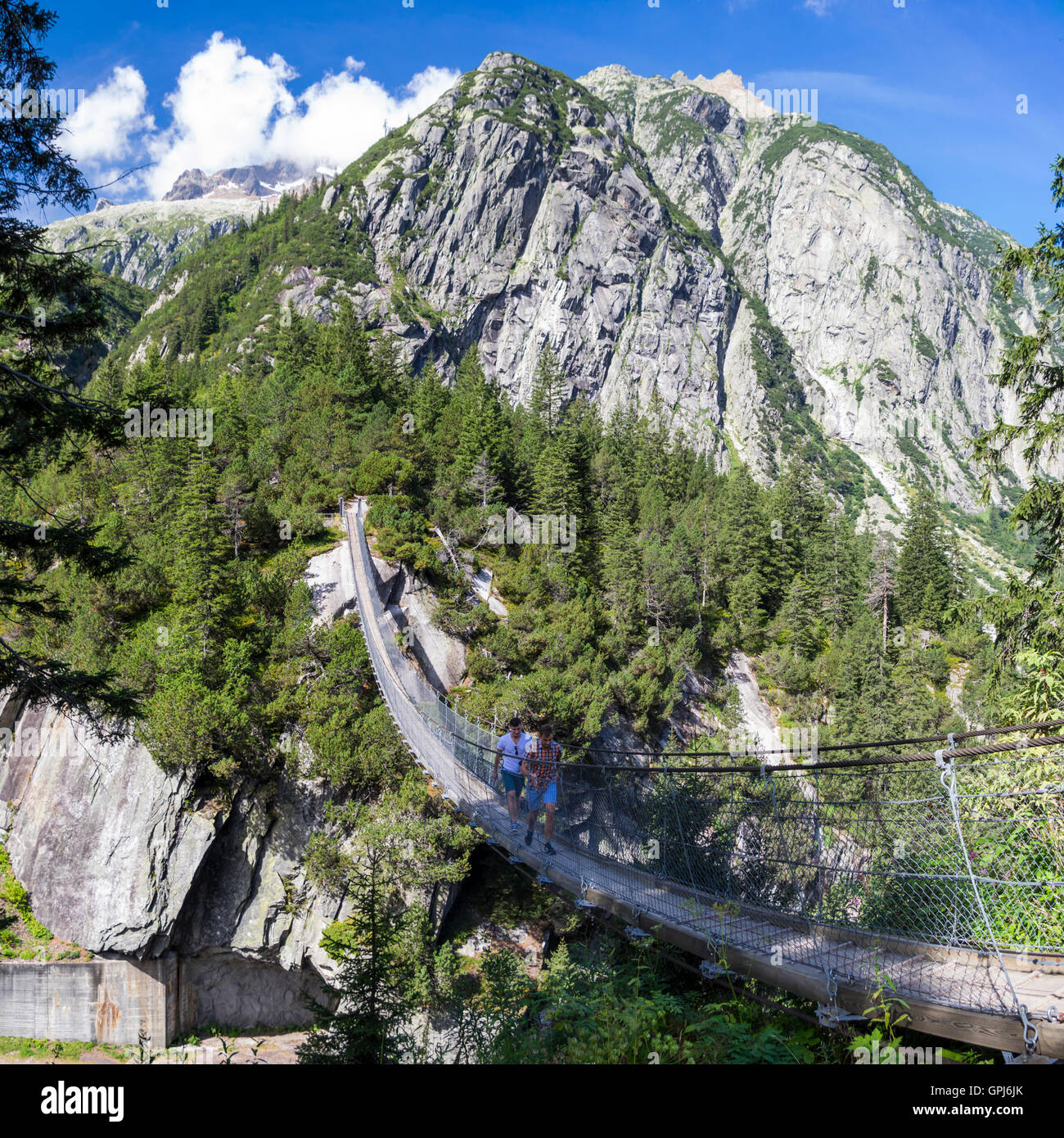 70m long and high pedestrian suspension bridge in the Alps. Handegg, Berner Oberland, Switzerland. Stock Photo
