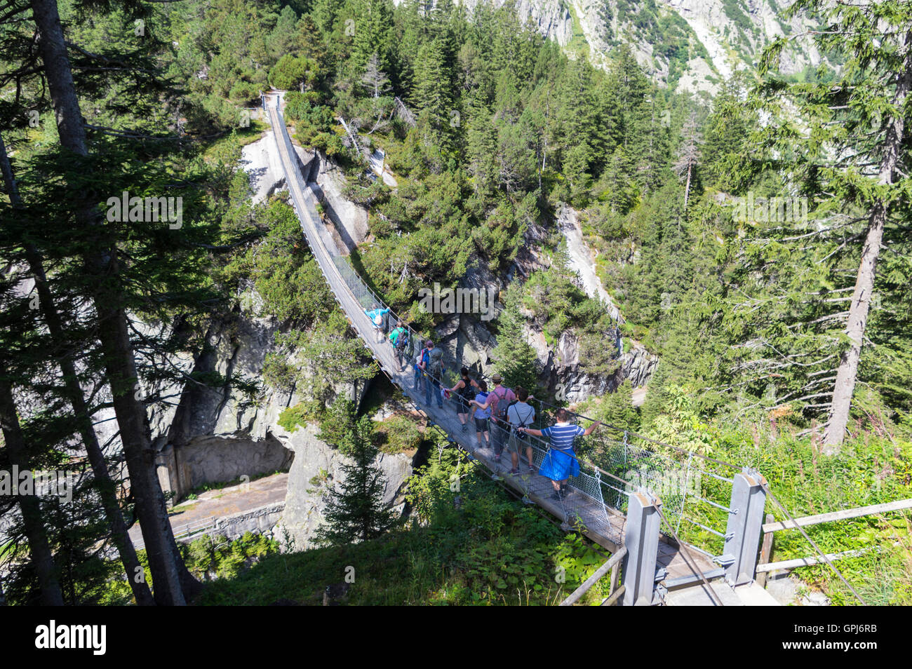 70m long and high pedestrian suspension bridge for hikers in the Alps. Handegg, Berner Oberland, Switzerland. Stock Photo