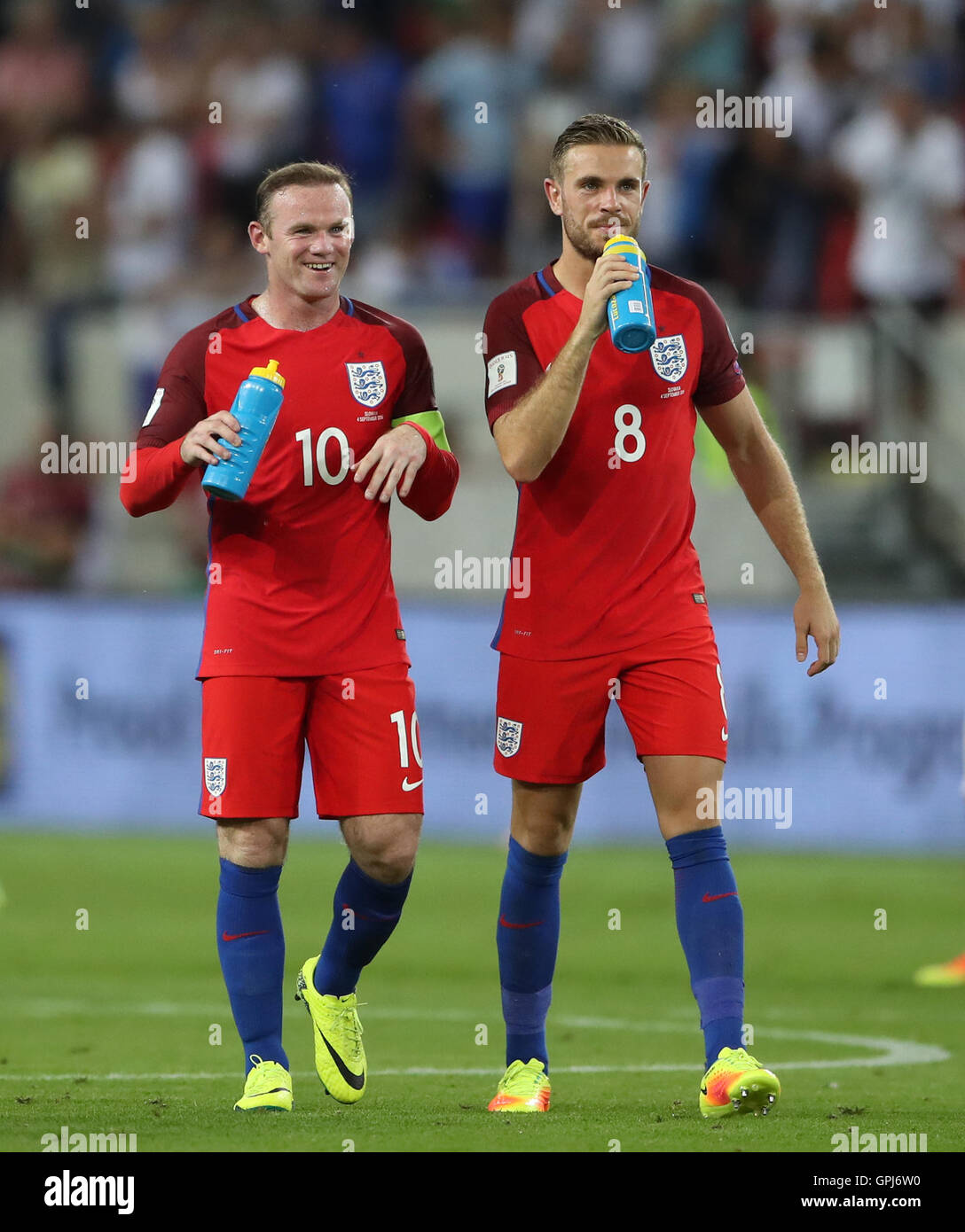 England's Wayne Rooney (left) and Jordan Henderson take on fluids after the 2018 FIFA World Cup Qualifying match at the City Arena, Trnava. Stock Photo