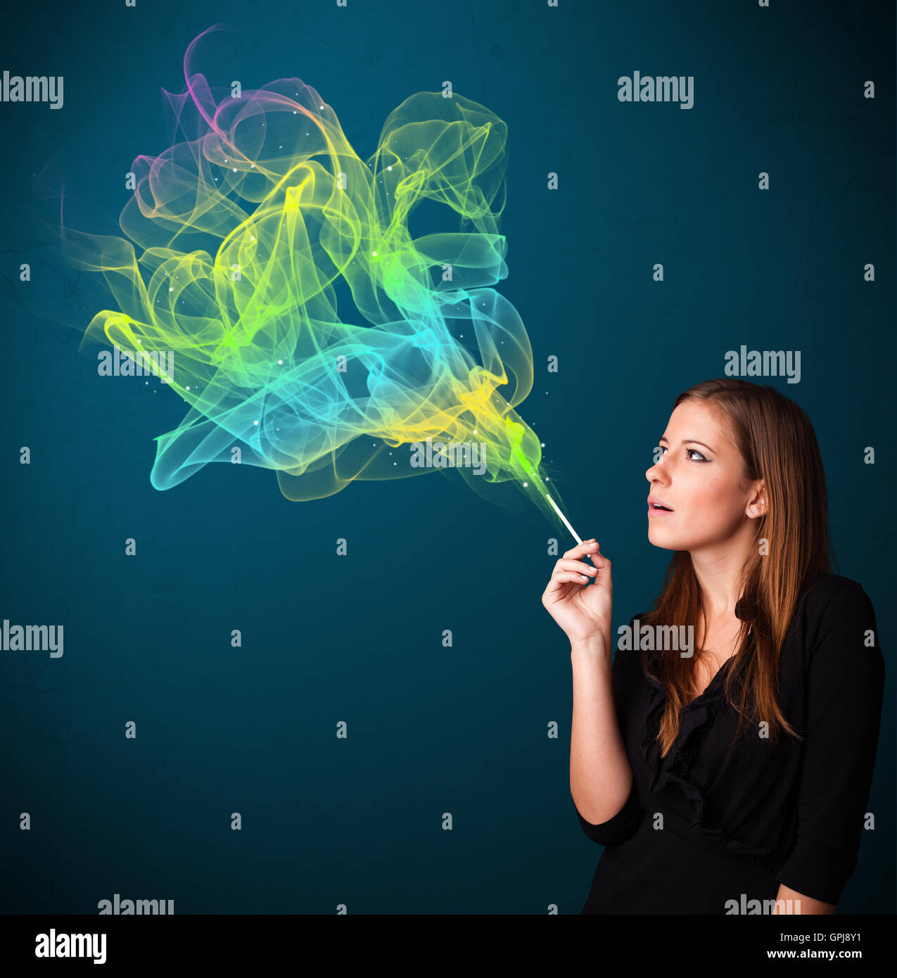 Pretty lady smoking cigarette with colorful smoke Stock Photo