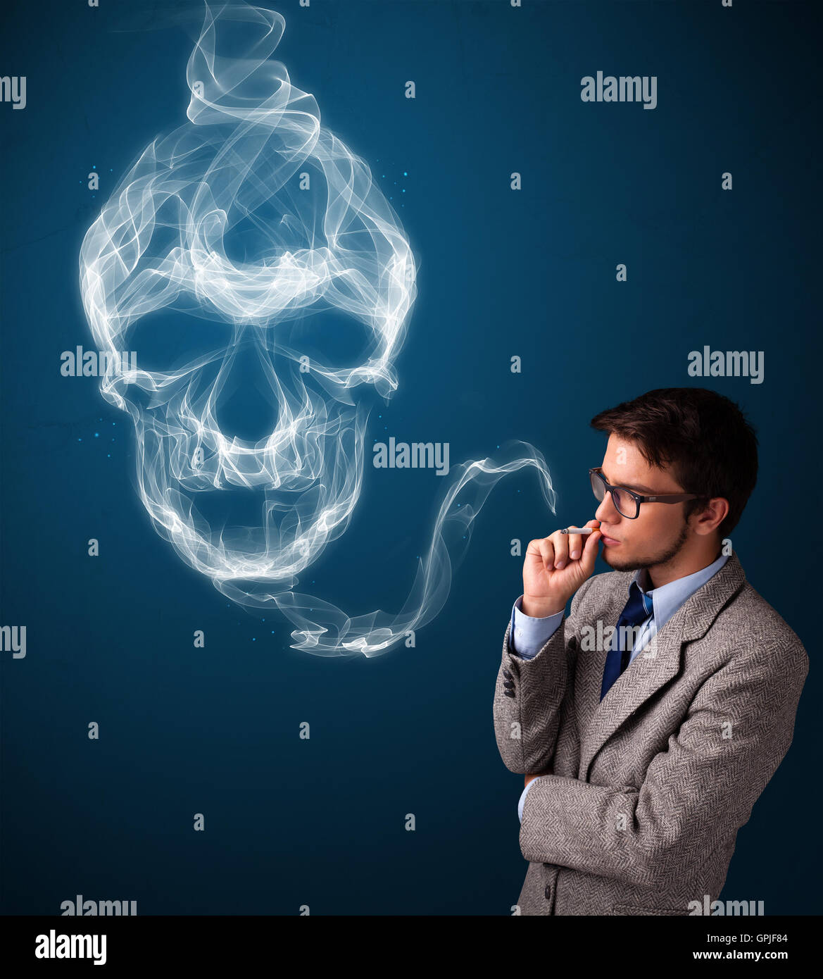 Young man smoking dangerous cigarette with toxic skull smoke Stock Photo Alamy