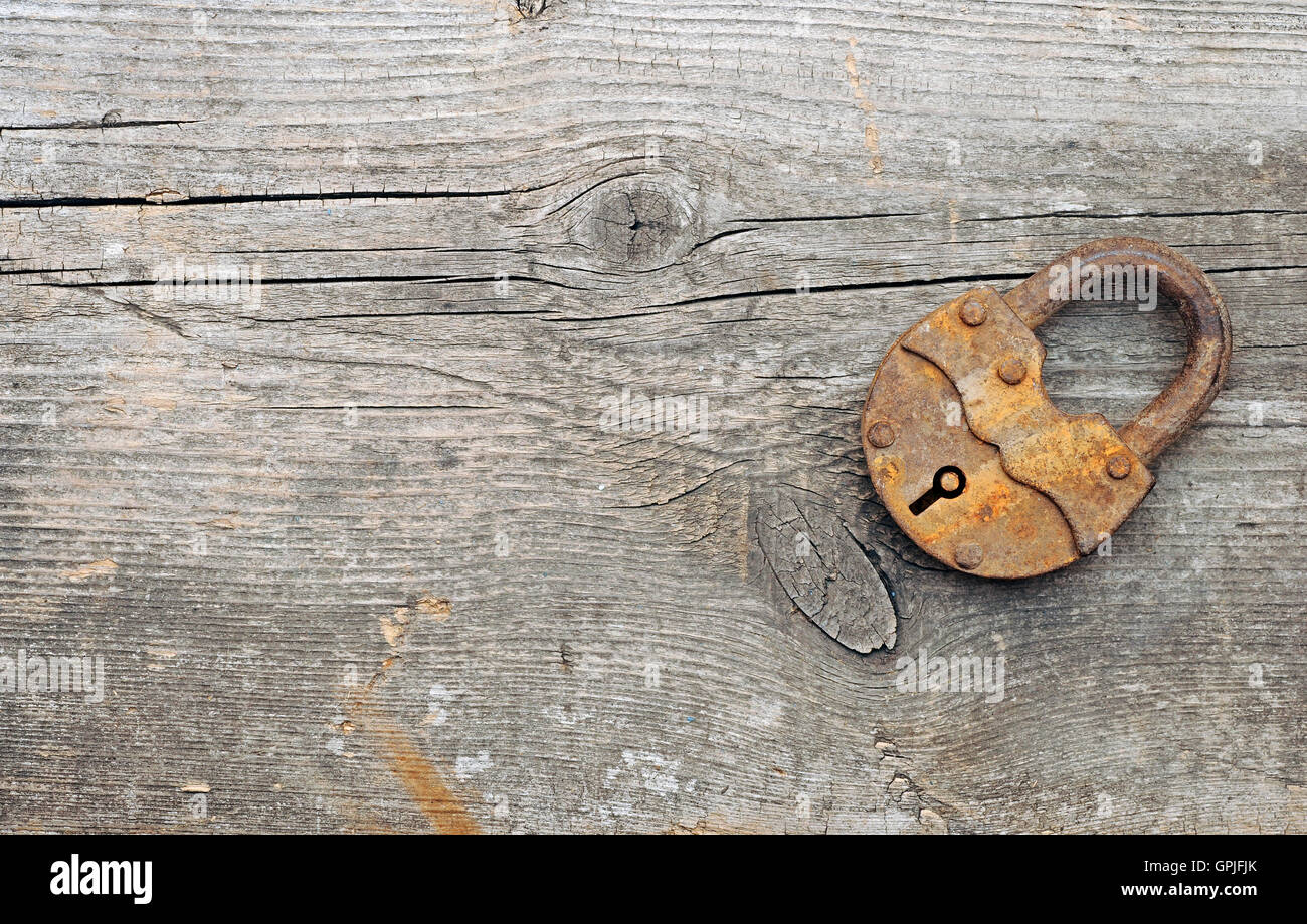 Old padlock over wooden background.With copy space Stock Photo