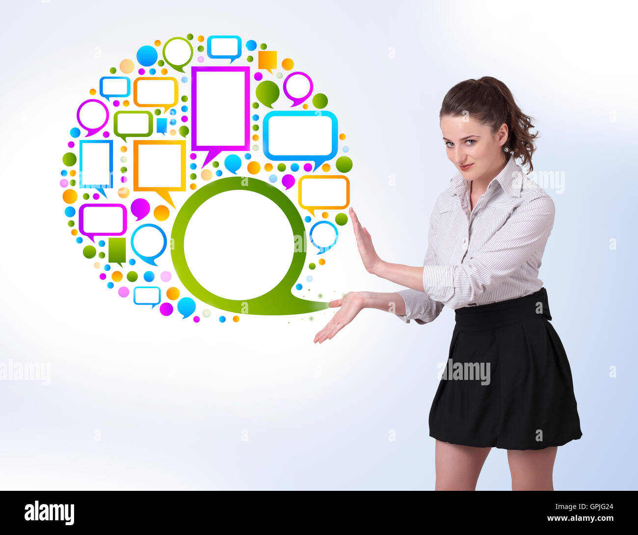 Young business woman presenting colourful speach bubble Stock Photo - Alamy
