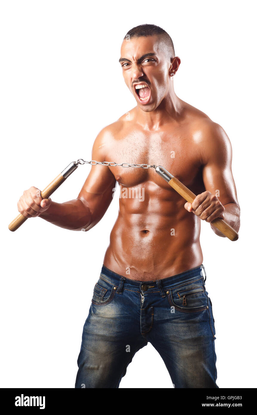 Man in martial arts concept with nunchucks Stock Photo Alamy