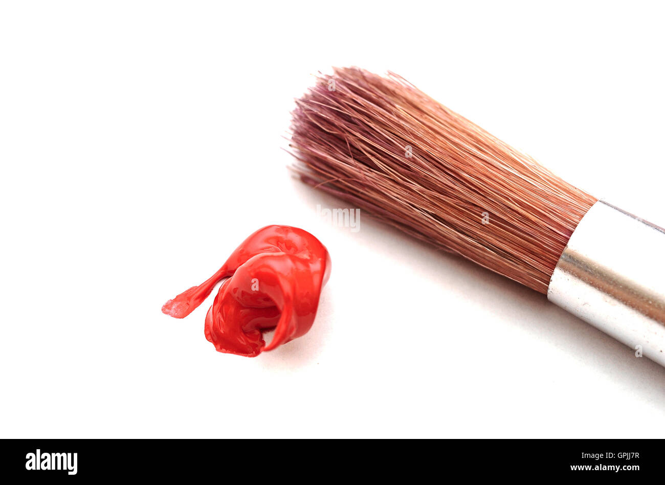 Paintbrush and red color on white Stock Photo