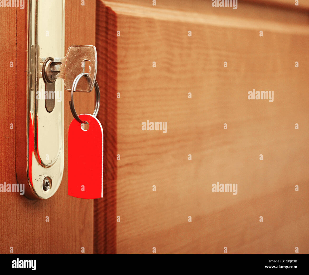key in keyhole with blank label Stock Photo Alamy