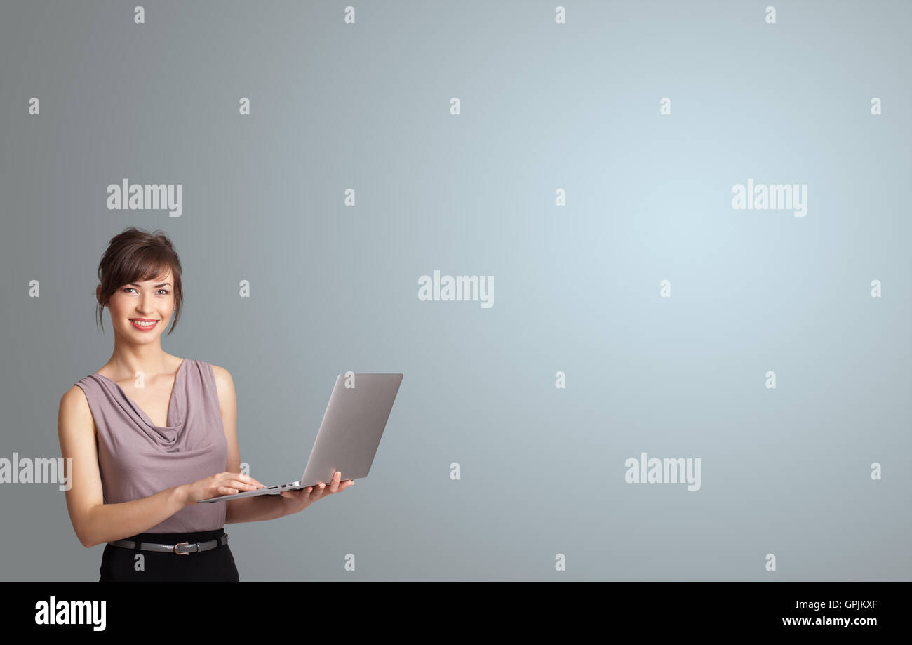 attractive woman holding a laptop with copy space Stock Photo - Alamy