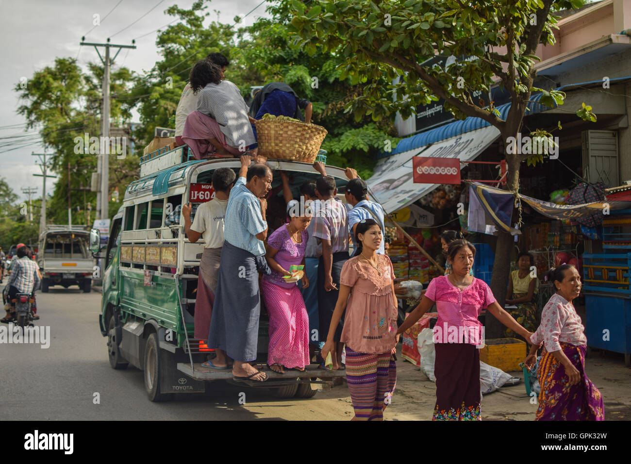 Too many people on one car in Mandalay, Myanmar Stock Photo