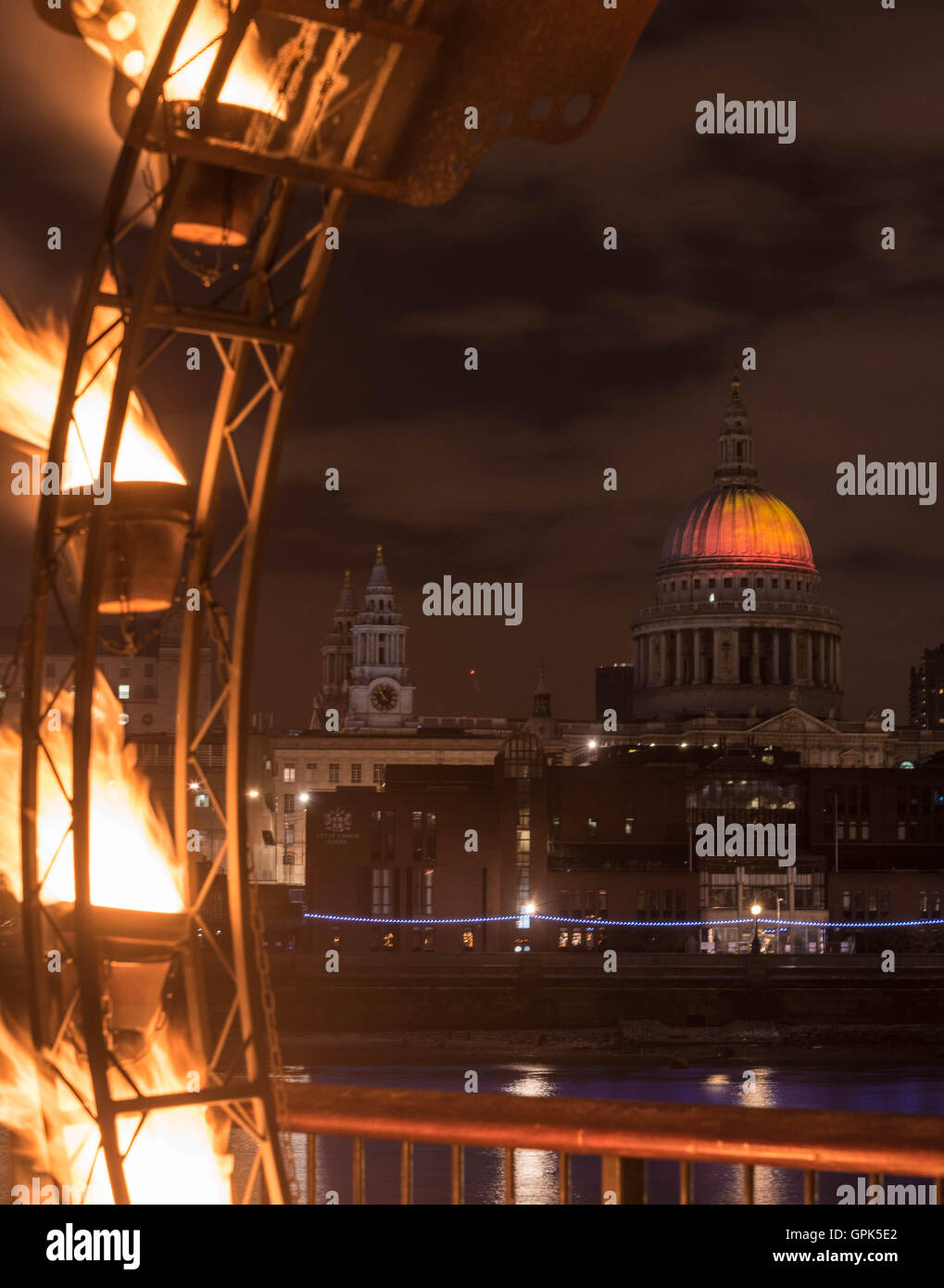 London, UK, 02 September 2016, view of projection of ‘Fires of  London’ by artist Martin Firrell celebrating the ability of people and places to overcome adversity on to dome of St Paul’s Cathedral from ‘Fire Garden’ by French fire artists Compagnie Carabosse in the grounds of Tate Modern on the south bank of the River Thames - two of the events in the ‘London’s Burning - Great Fire 350’ Festival of Art and Ideas Credit:  Yvette McGreavy/Alamy Live News Stock Photo