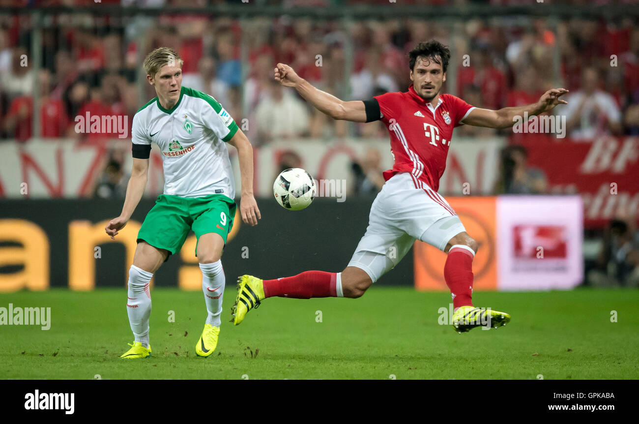 Munich, Germany. 26th Aug, 2016. Bayern's Mats Hummels (red) and Bremen's Aron Johannsson in action during the Bundesliga soccer match between FC Bayern Munich and SV Werder Bremen at Allianz Arena in Munich, Germany, 26 August 2016. PHOTO: THOMAS EISENHUTH/dpa - NO WIRE SERVICE - © dpa/Alamy Live News Stock Photo