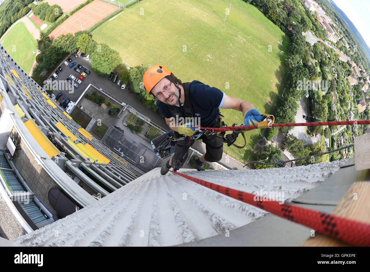 Karlsruhe, Germany. 11th Aug, 2016. Industrial climber Juergen Heinz-Pommer working on the facade of a skyscraper in Karlsruhe, Germany, 11 August 2016. PHOTO: ULI DECK/dpa/Alamy Live News Stock Photo