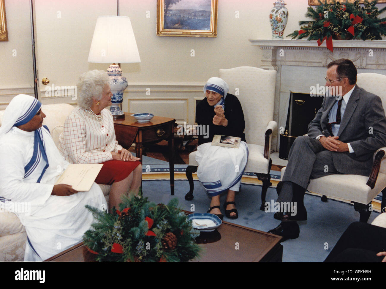 United States President George H.W. Bush, right, and first lady Barbara Bush, center left, meet with Mother Teresa, founder, Roman Catholic Missionaries of Charity, center right, in the Oval Office of the White House in Washington, D.C. on December 9, 1991. Mandatory Credit: Carol T. Powers / The White House via CNP - NO WIRE SERVICE - Stock Photo