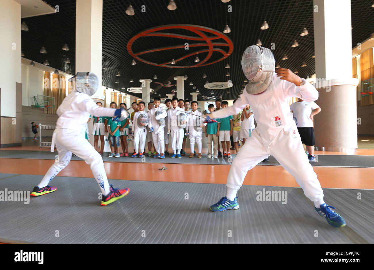 (160905) --JIMO, Sept. 5, 2016 (Xinhua) -- Students take fencing training at Tongji Experimental School in Jimo, east China's Shandong Province, Sept. 5, 2016. This school opened over 20 extra curriculums on robotic soccer, model airplane, opera mask painting, fencing, etc to enrich students' campus life. (Xinhua/Liang Xiaopeng) (wf) Stock Photo