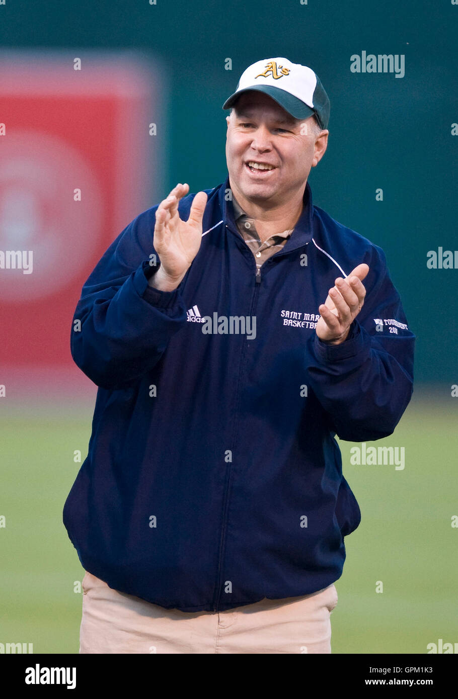 April 5, 2010; Oakland, CA, USA;  Saint Marys Gaels mens basketball head coach Randy Bennett applauds guard Mickey McConnell (not pictured) as he throws out the opening pitch before the game between the Oakland Athletics and the Seattle Mariners at Oaklan Stock Photo
